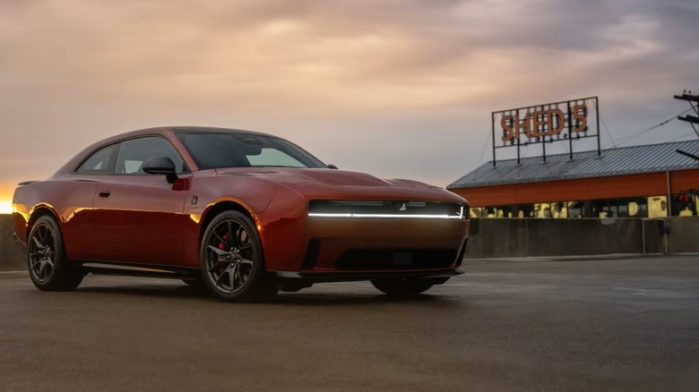 Dodge Charger BHP in red parked outside of retro restaurant with unlit sign.