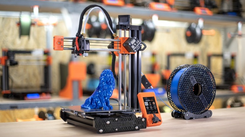 Original Prusa Mini+ on a worktop with a finished blue print of a lion.