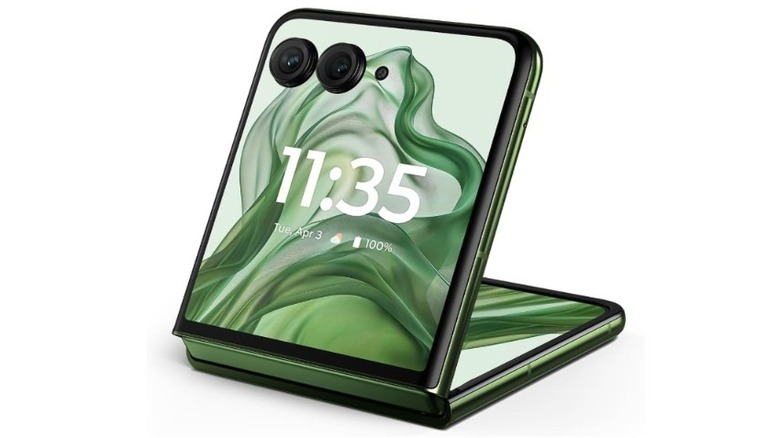 The Moto Razr+ 2024 foldable smartphone shown partially open, featuring a green finish.