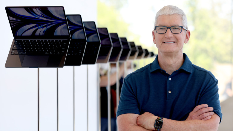 Apple CEO Tim Cook looks at a display of brand new redesigned MacBook Air laptop during the WWDC22 at Apple Park on June 06, 2022 in Cupertino, California. Apple CEO Tim Cook kicked off the annual WWDC22 developer conference.
