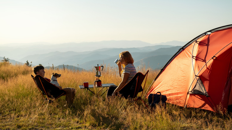 Two people camping in a hilly area