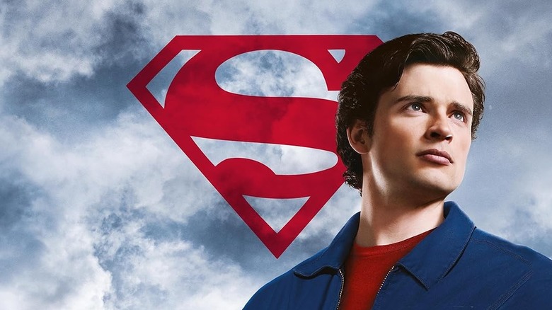 Tom Welling hero posing as Clark Kent in Smallville, with the Superman logo behind him