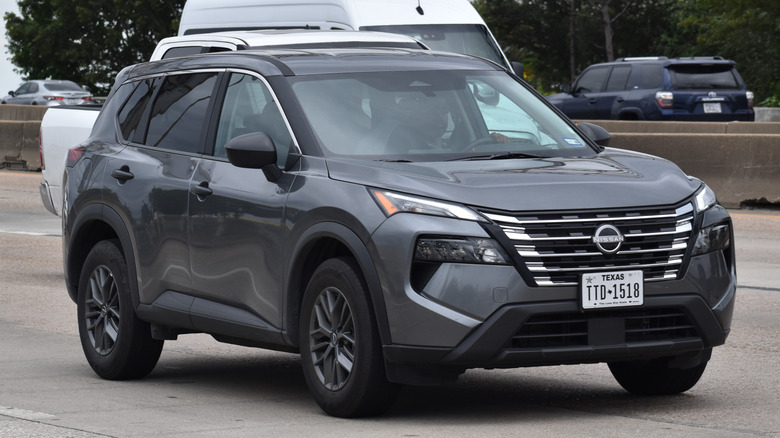 A gray Nissan Pathfinder on the road.