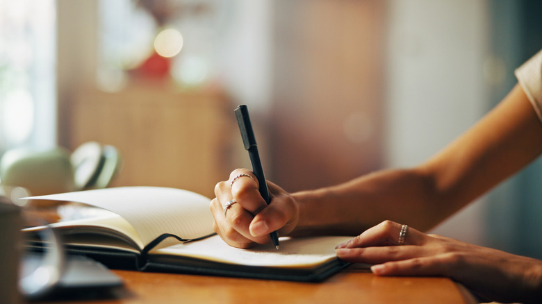 person writing in a notebook