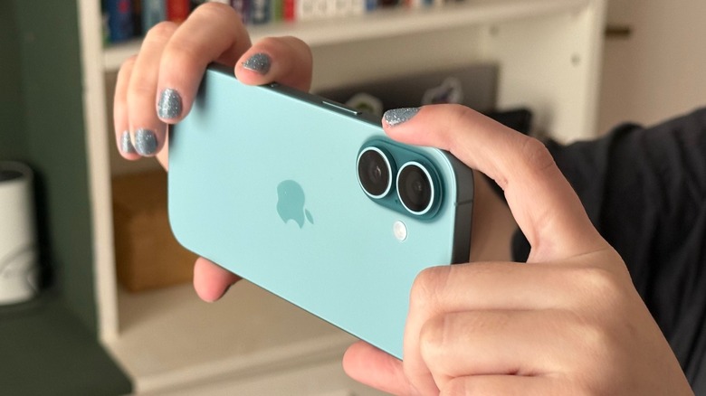 Close-up shot at a person taking a picture with an iPhone 16