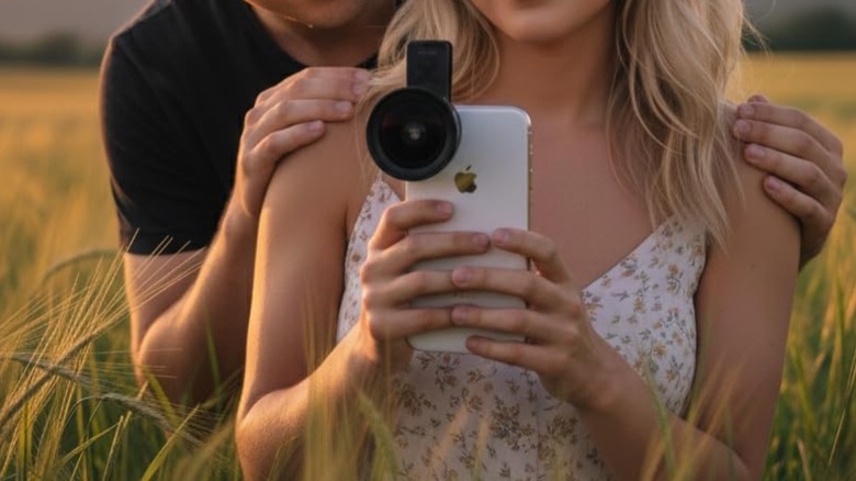 Couple taking a picture with an iPhone