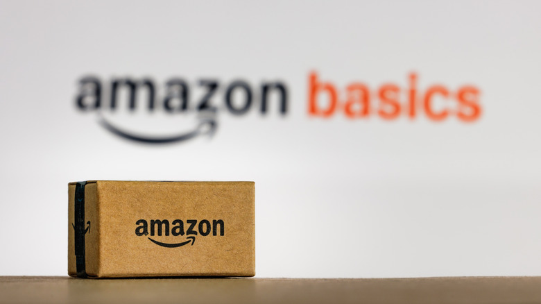 Amazon logo on the side of a package in front of a blurred Amazon Basics logo