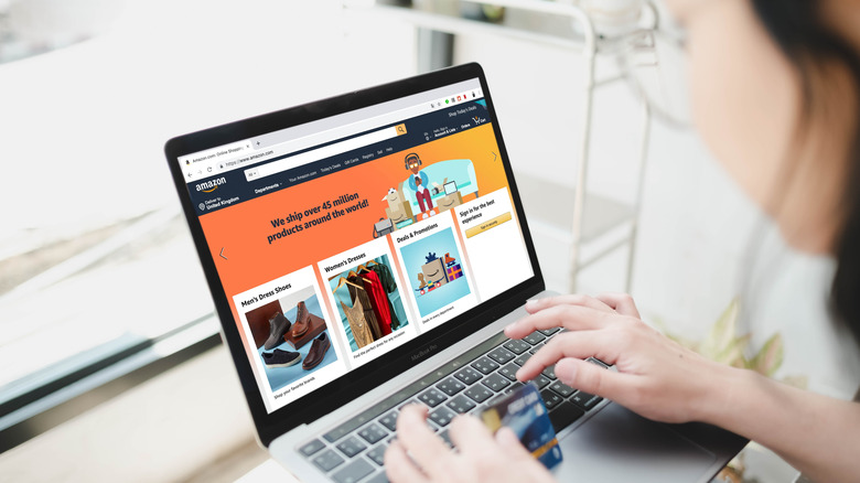 a woman browsing the Amazon website on a laptop