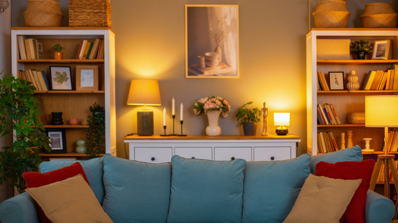 A living room illuminated by several sources of warm lighting.
