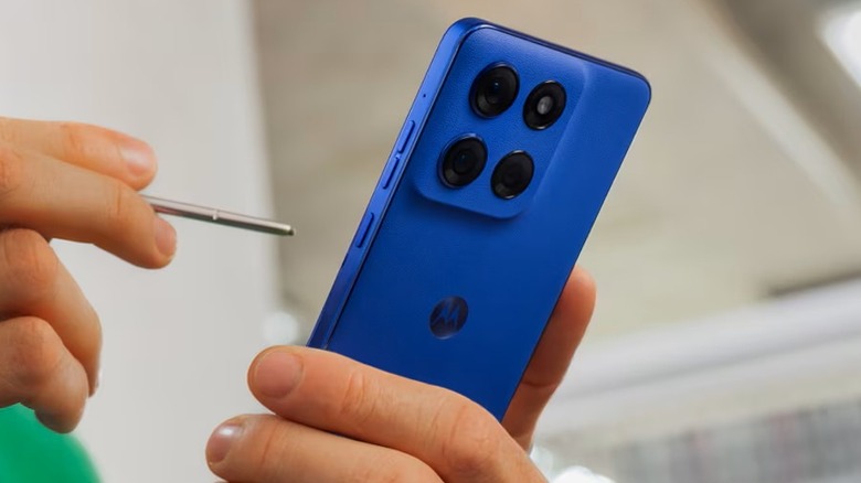 Person holding a blue Moto G Stylus (2025) phone with the stylus out