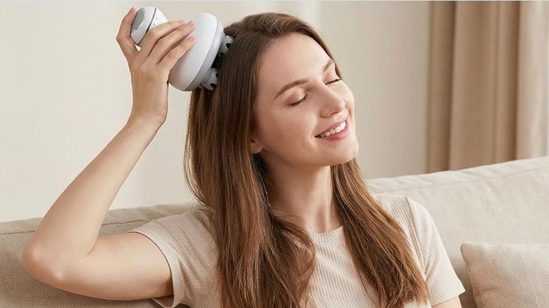 An individual using the Comfier Electric Cordless Hair Scalp Massager to massage their head