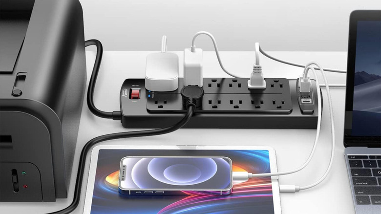Several devices plugged into the Alestor 12-outlet surge protector