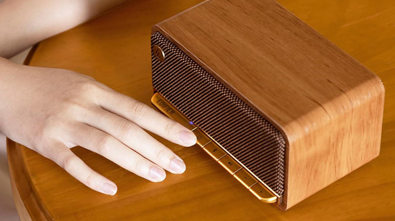 Pressing a button on the Edifier retro Bluetooth speaker