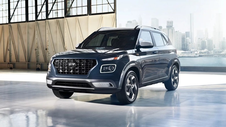 2026 Hyundai Venue in hangar setting with city in background.