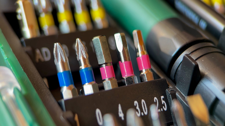 Screwdriver bits, sitting upward in their labeled holder
