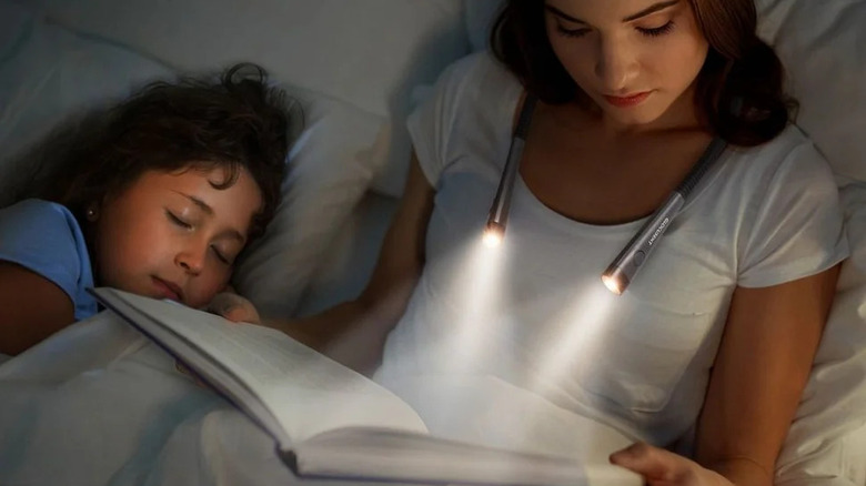 Woman using Glocusent Book Light while reading in bed