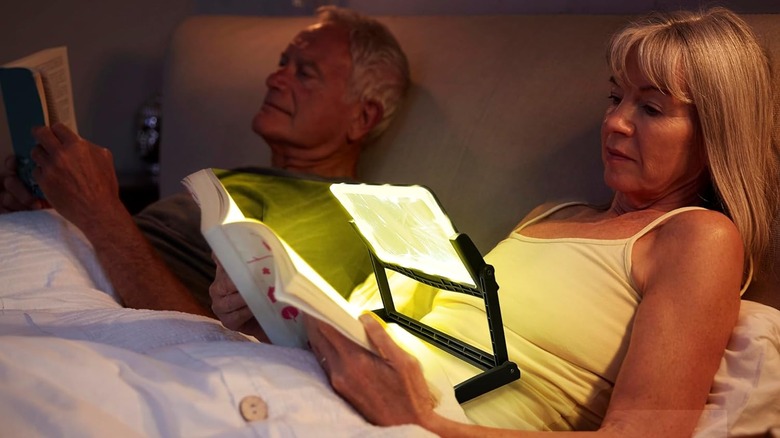 Person using MagniPros Page Magnifier in bed
