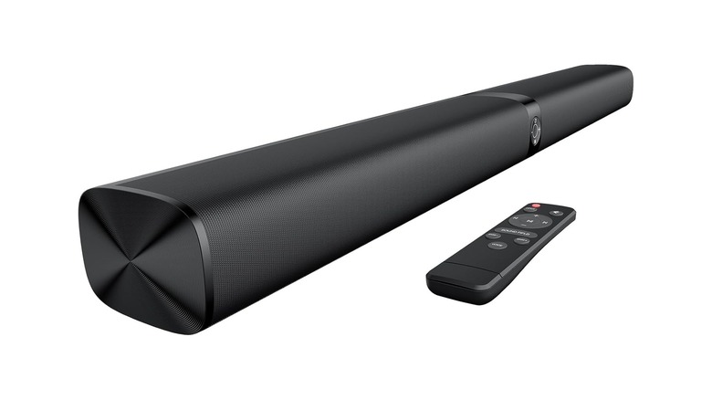 A soundbar sitting on a blank white background with a remote next to it