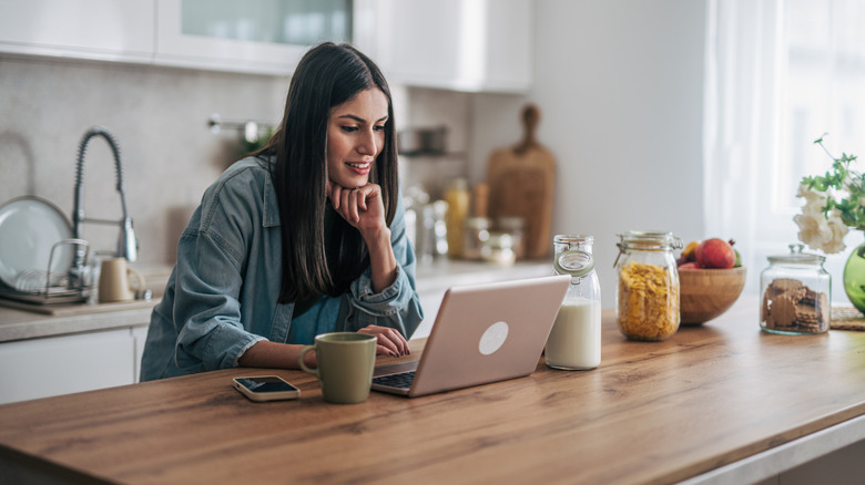 A woman using a laptop at home over Wi-Fi connection