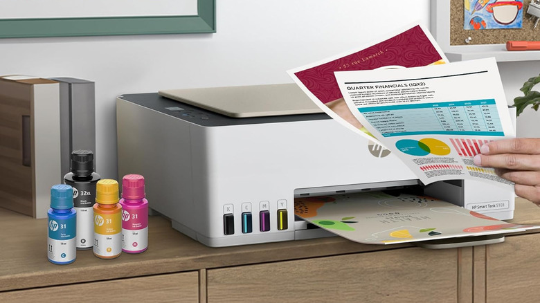 HP Smart Tank printer producing a colorful document on a wooden desk