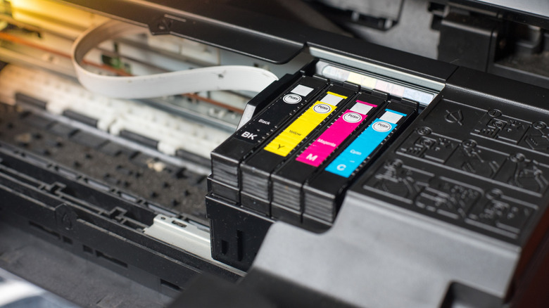 Color ink cartridges installed inside a printer.
