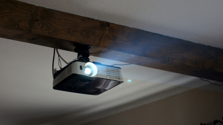 A projector mounted attached to the ceiling