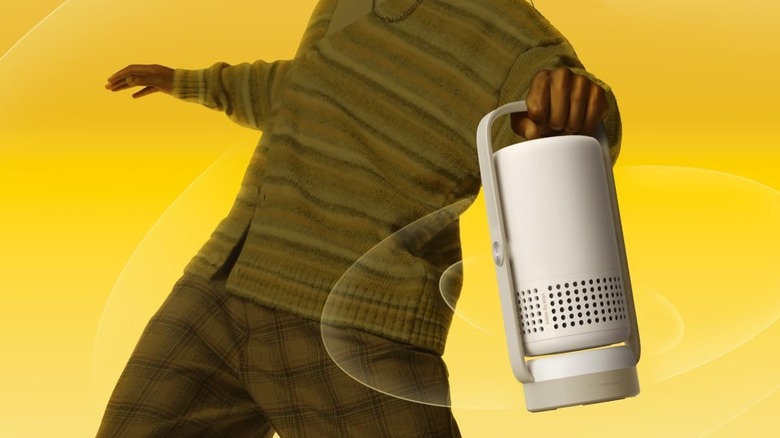 A person holding the XGIMI Vibe One.