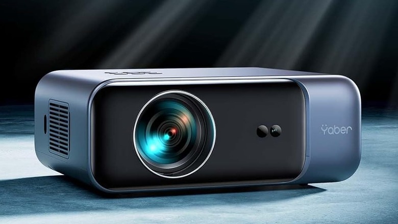 The Yaber Pro V9 on a gray surface with a black cloth background.