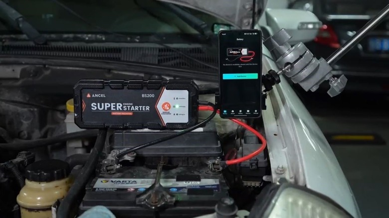 Ancel BS200 super starter connected to battery with app UI visible.