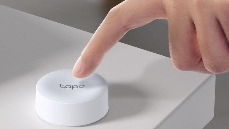 Finger about to push Tapo Smart Button
