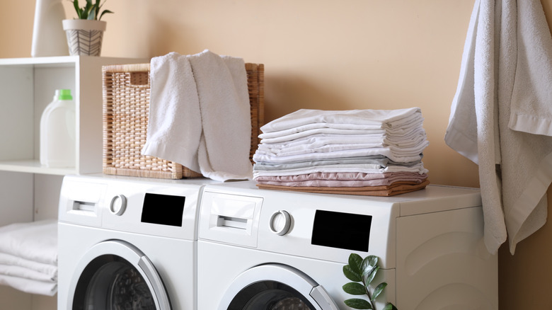 Stack of laundry on top of washer and dryer