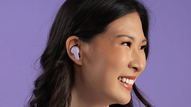 A woman wearing JLab Go Pods ANC earbuds.