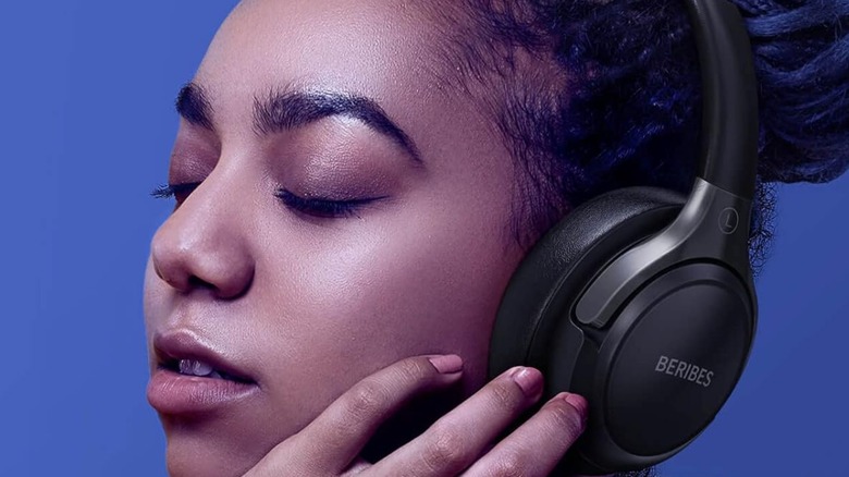 A woman wearing a pair of Beribes headphones.