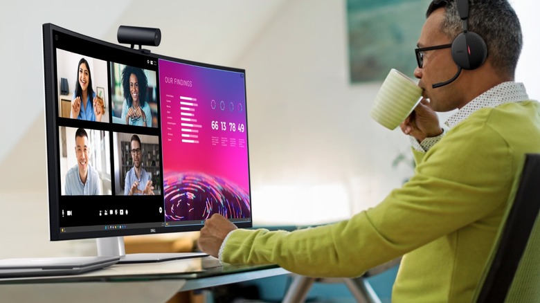 A man on a video call on Dell's ultrawide monitor