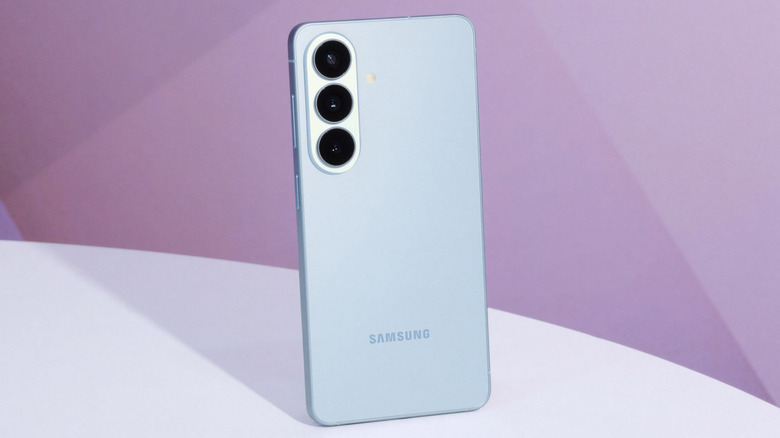 The Samsung Galaxy S26 kept on a solid surface with a pink background