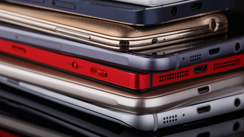 A stack of premium smartphones in varying colors