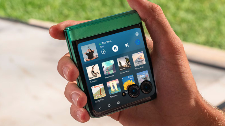 A hand holding the Motorola Razr in the folded position