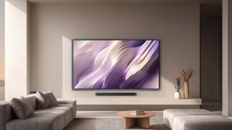 The Samsung S95H OLED TV mounted ona wall in a living reoom setup