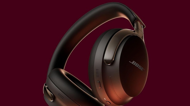 The Bose QuietComfort Ultra headphones against a dark red background