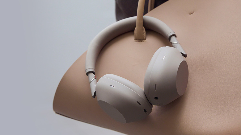 The Sony WH-1000XM6 headphones hanging on a bag strap