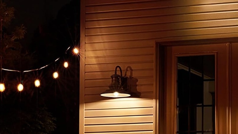 The GE CYNC Outdoor Flood Light being used for an outdoor light on a patio.