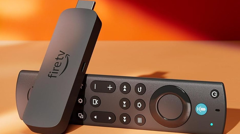Amazon Fire TV Stick 4K Max and remote on an orange background.