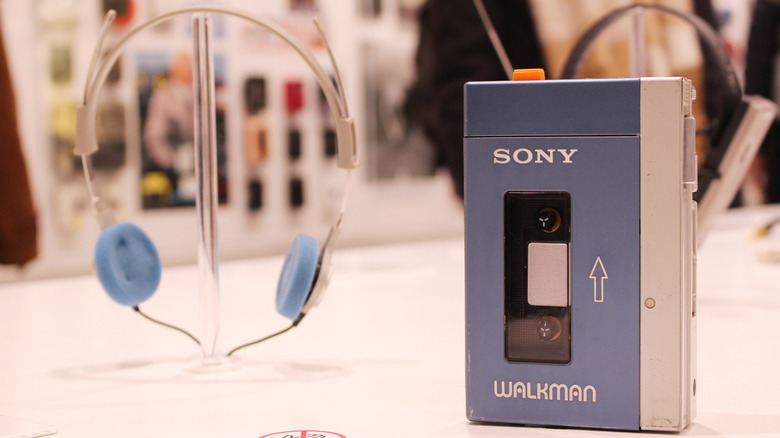 A Sony Walkman and headphones on display in a museum.