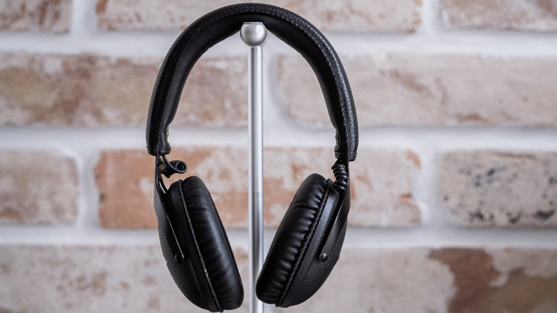 Over-ear headphones resting on a stand.