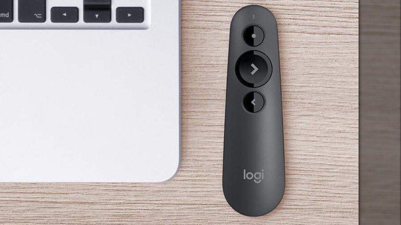 The Logitech R500 Wireless Presentation Clicker sitting on a wooden desk