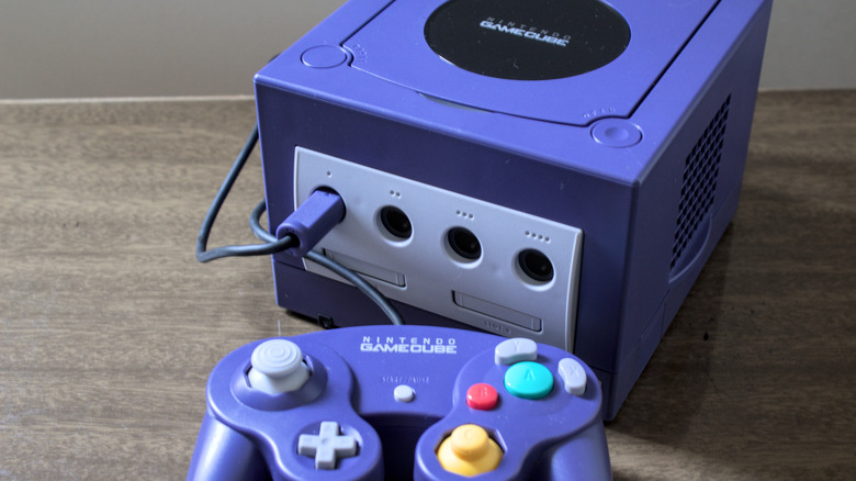 A Nintendo GameCube and controller on a table.