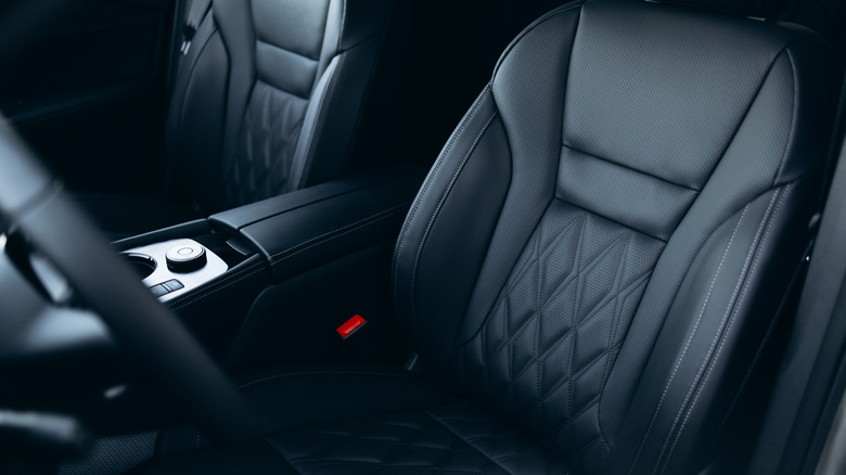 A photo of a black car seat inside a vehicle with black interior