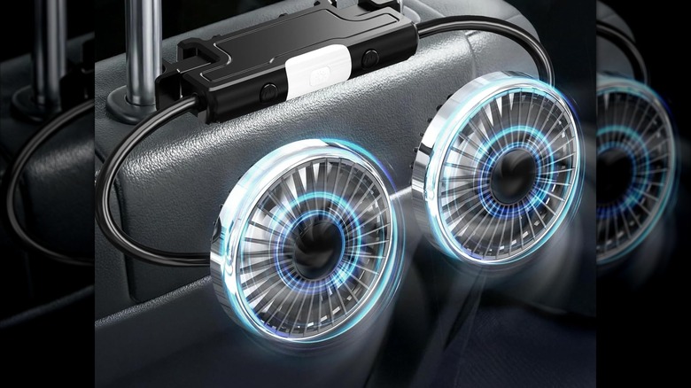 The Huenlyel Backseat Rear Facing Fan attached to the arms of a vehicle's headrest