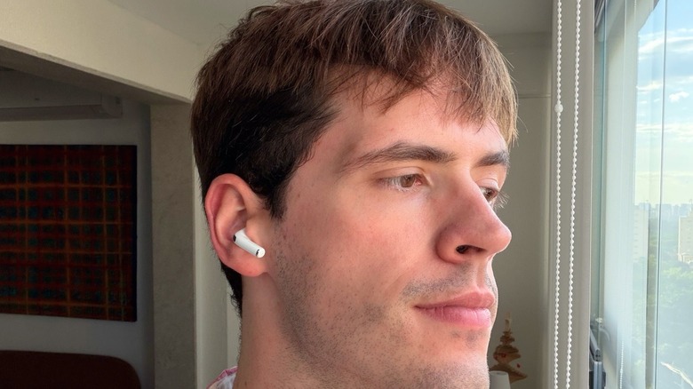 A man wearing AirPods Pro 3