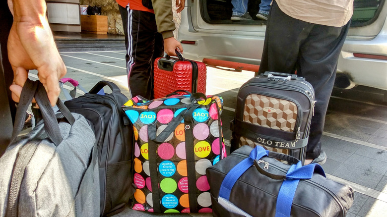 Packing multiple bags into a car after a trip